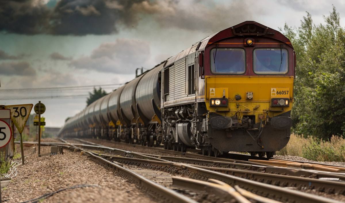 Freight locomotive hauling tank wagons along railway tracks