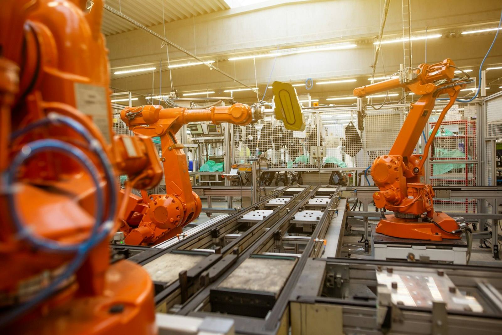 Industrial robot arms operating on an automated production line